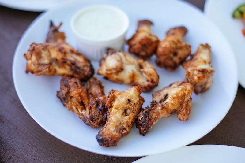 Spicy chicken bites bowl with sauce and garnish